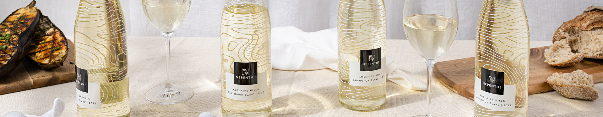 Nepenthe Ascend Sauvignon bottle in a dinner table setting with pasta.